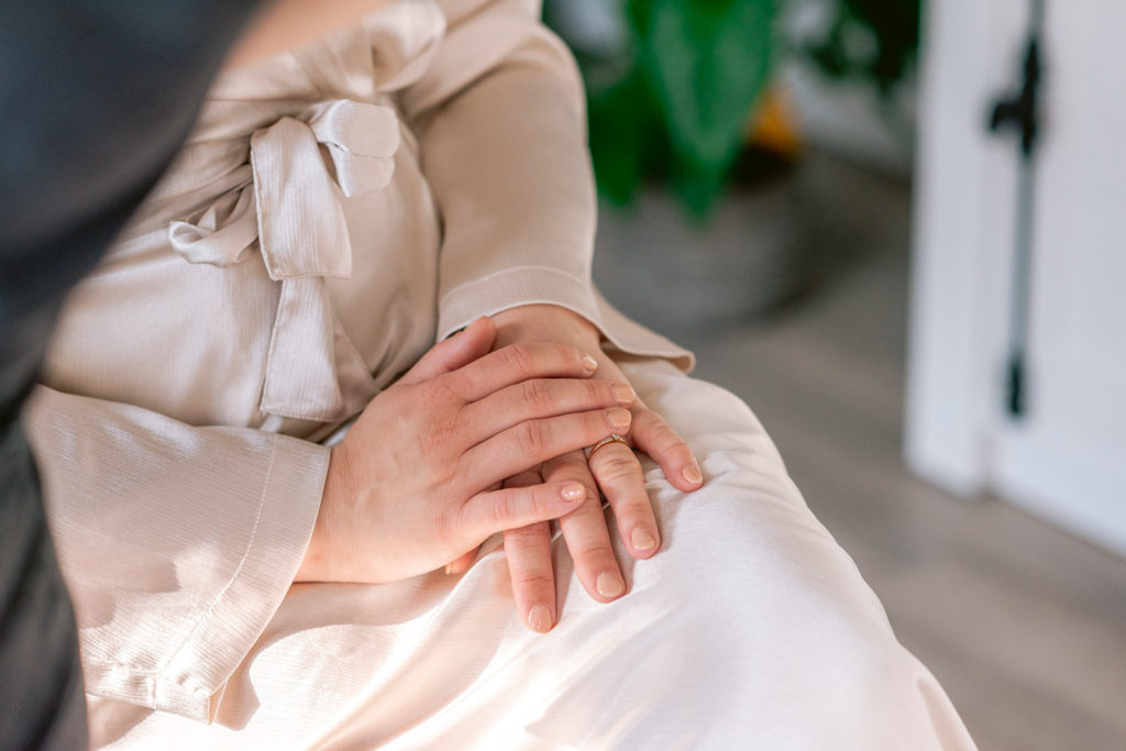Bruid zit met handen over elkaar in haar kimono